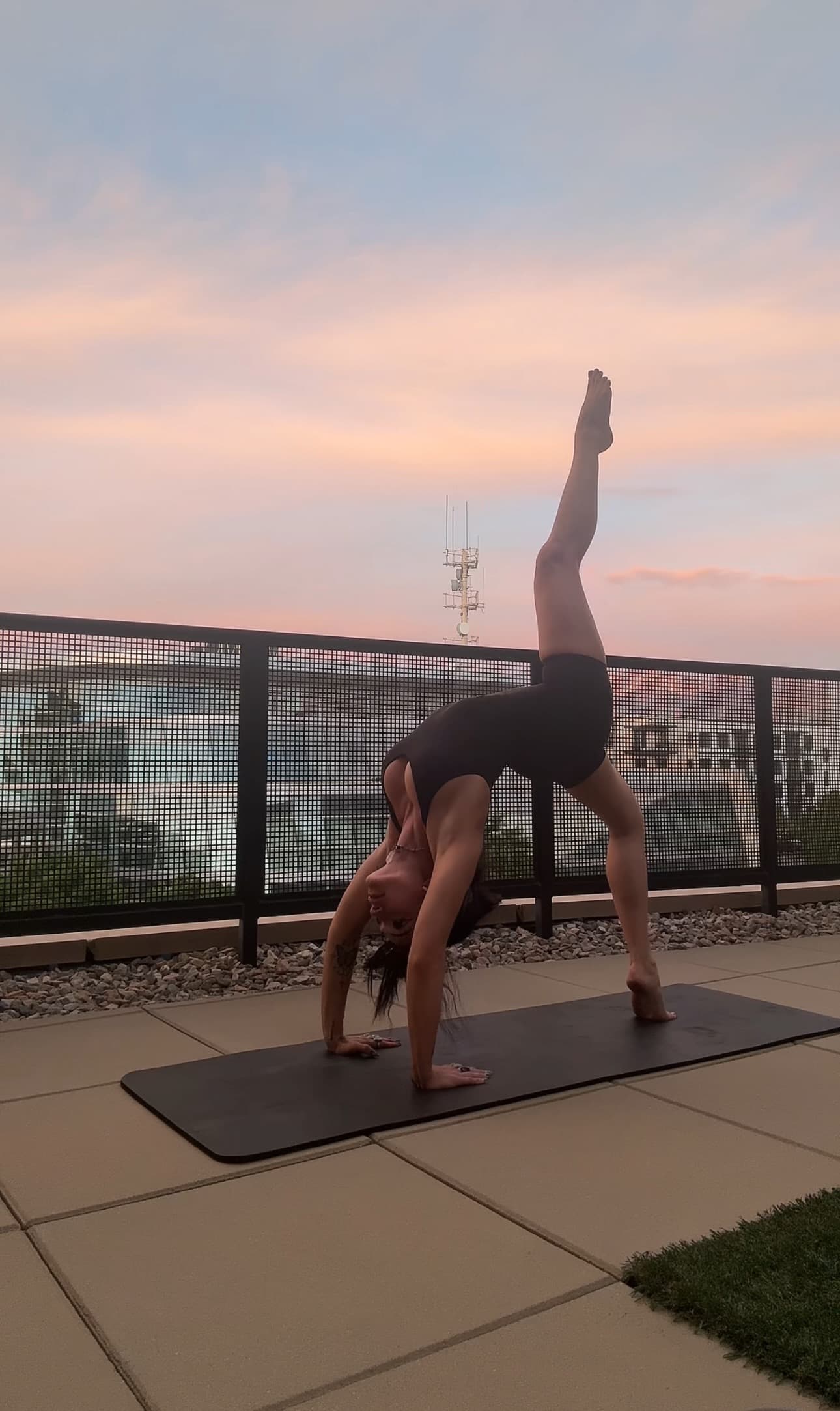 Blaire doing yoga on a rooftop
